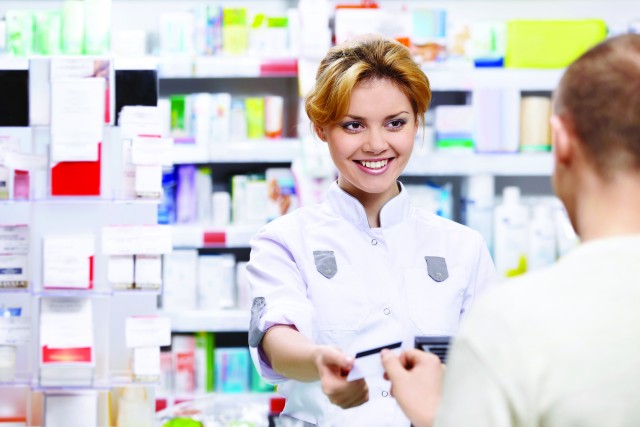 The pharmacist sells the medicine in a pharmacy