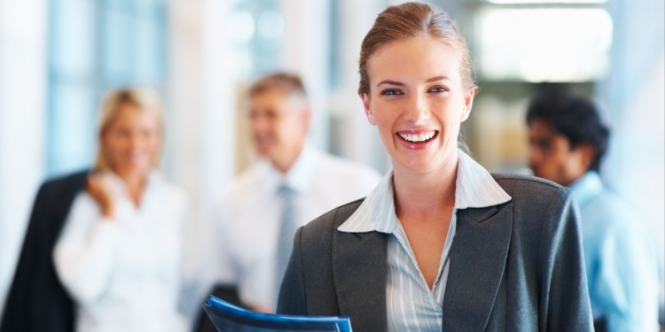 happy young business woman colleagues in the background