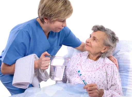 nurse helps the senior woman in washing