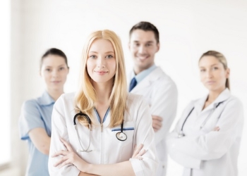 attractive female doctor in front of medical group