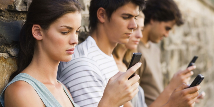 closeup portrait of young men and women holding cellphone