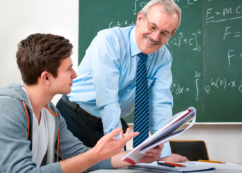 male student with a teacher in classroom