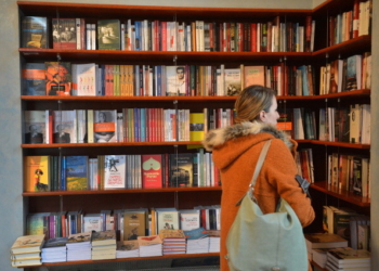 TO GO WITH AFP STORY by ISABELLE WESSELINGH and MIHAELA RODINA - A woman looks at the contemporary Romanian literature bookshelf at a library in Bucharest March 21, 2013. "Medicine of the soul" in a country fragmented, "black box" to decrypt the ravages of totalitarianism, yet nourished poetry, contemporary Romanian literature finds its way into Europe despite the lack of resources in the country and prejudices abroad. Romania is the guest of honor at the "Salon du Livre" Paris Book Fair running from March 22 to 25, 2013, the opportunity to discover new talents in a country whose writers such as Cioran and Mircea Eliade conquered a worldwide reputation in the past.   AFP PHOTO/DANIEL MIHAILESCU        (Photo credit should read DANIEL MIHAILESCU/AFP/Getty Images)