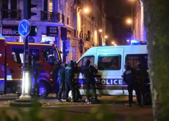 epa05024070 Police officers gather outside the Bataclan concert venue in Paris, France, 13 November 2015. At least 149 people have been killed in a series of attacks in Paris on 13 November, according to French officials.  EPA/CHRISTOPHE PETIT TESSON