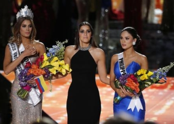 Former Miss Universe Paulina Vega, center, reacts before taking away the flowers, crown and sash from Miss Colombia Ariadna Gutierrez, left, before giving it to Miss Philippines Pia Alonzo Wurtzbach at the Miss Universe pageant Sunday, Dec. 20, 2015, in Las Vegas. Gutierrez was incorrectly named Miss Universe. (ANSA/AP Photo/John Locher)