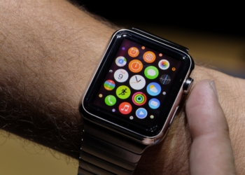 An attendee demonstrates the Apple Watch after a product announcement at Flint Center in Cupertino, California, U.S., on Tuesday, Sept. 9, 2014. Apple Inc. unveiled redesigned iPhones with bigger screens, overhauling its top-selling product in an event that gives the clearest sign yet of the company's product direction under Chief Executive Officer Tim Cook. Photographer: David Paul Morris/Bloomberg