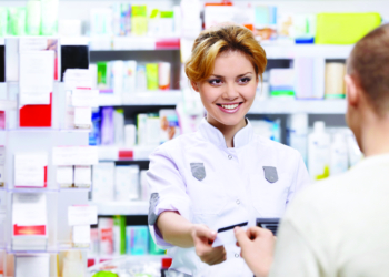 The pharmacist sells the medicine in a pharmacy