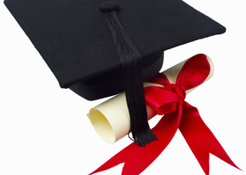 Close up of a graduation cap and a certificate with a ribbon --- Image by © Royalty-Free/Corbis