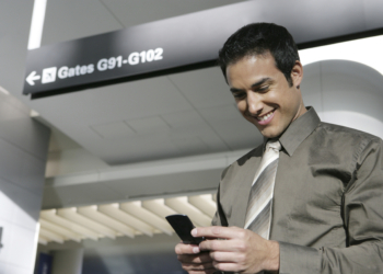 Businessman text messaging in airport