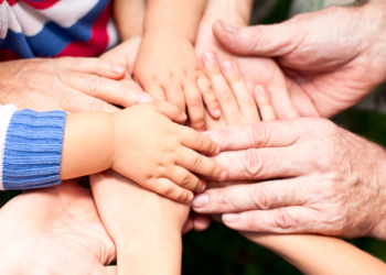 Family holding hands together closeup