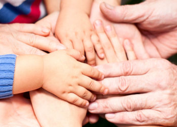 Family holding hands together closeup