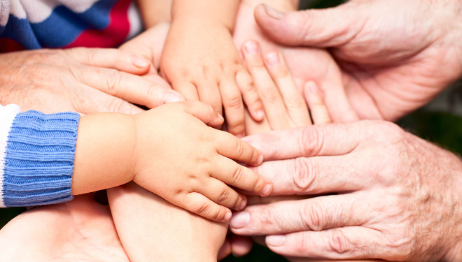 family holding hands together closeup