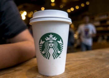 CHENGDU, SICHUAN PROVINCE, CHINA - 2015/09/13: Coffee cup on table in a Starbucks cafe.  Starbucks is streamlining the ordering process so customers are able to get that cup of coffee  faster than usual. (Photo by Zhang Peng/LightRocket via Getty Images)