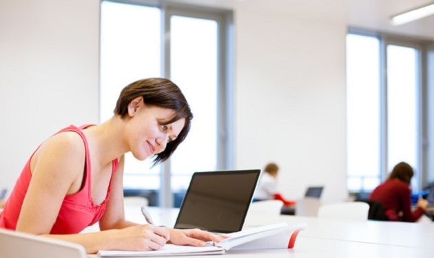 pretty young college student studying in the librarya study ro