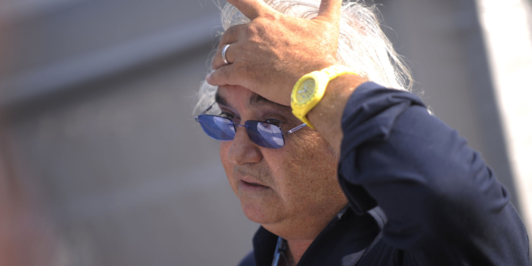 former renault f1 principal flavio briatore gestures in the paddock after the qualifying session of the italian f1 grand prix at the monza circuit