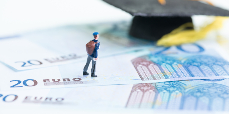 miniature man with 20 euro banknotes and mortar board