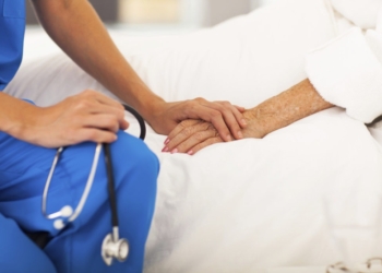 medical doctor comforting senior patient