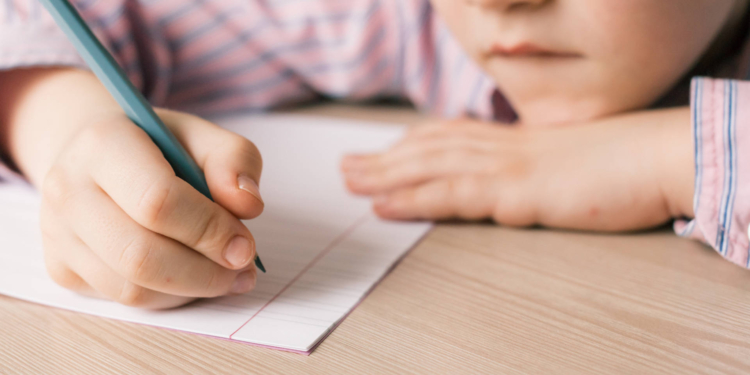 boy writing in notebook