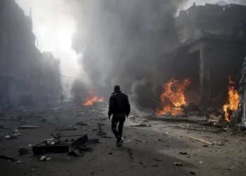 A man inspects a site hit by what activists said were airstrikes by forces loyal to Syria's President Bashar al-Assad, in the Douma neighborhood of Damascus, Syria November 7, 2015. REUTERS/Bassam Khabieh